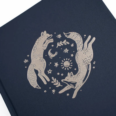 Navy blue notebook with white fox illustration on a white background