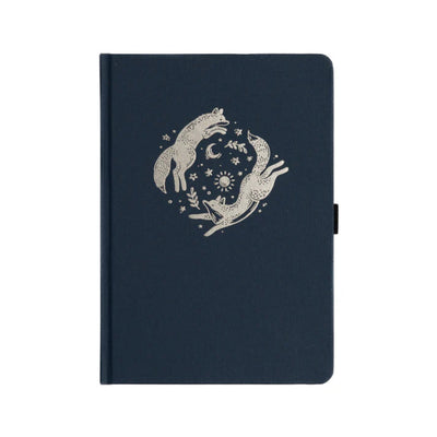 Archer & olive forest foxes notebook with white illustration of wolves and celestial design on a white background