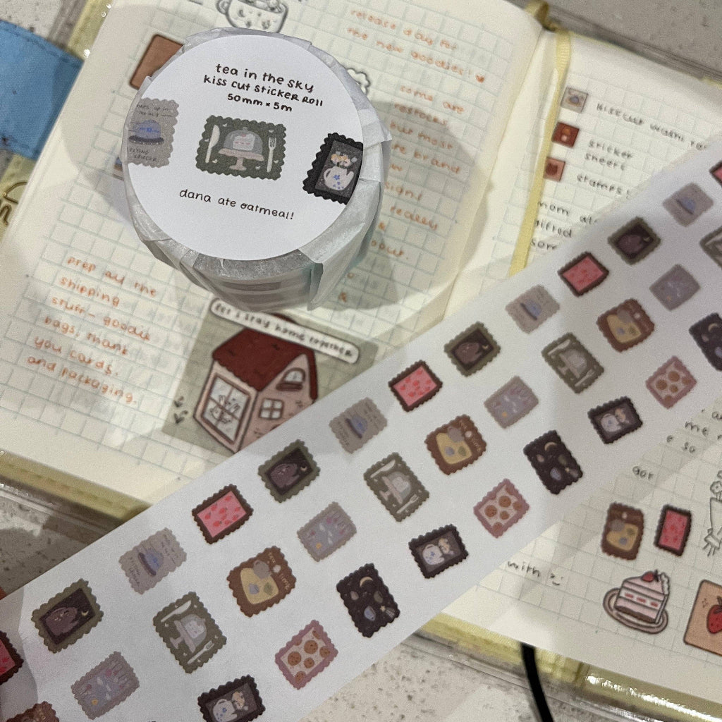 Decorative washi tape with small square stickers on a notebook