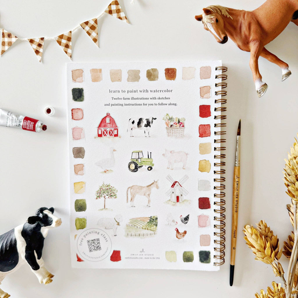 Washable paint book with farm illustrations on a white surface with paint bottles and figurines.