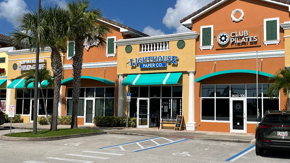 Commercial building with multiple businesses including Lighthouse Paper Co.