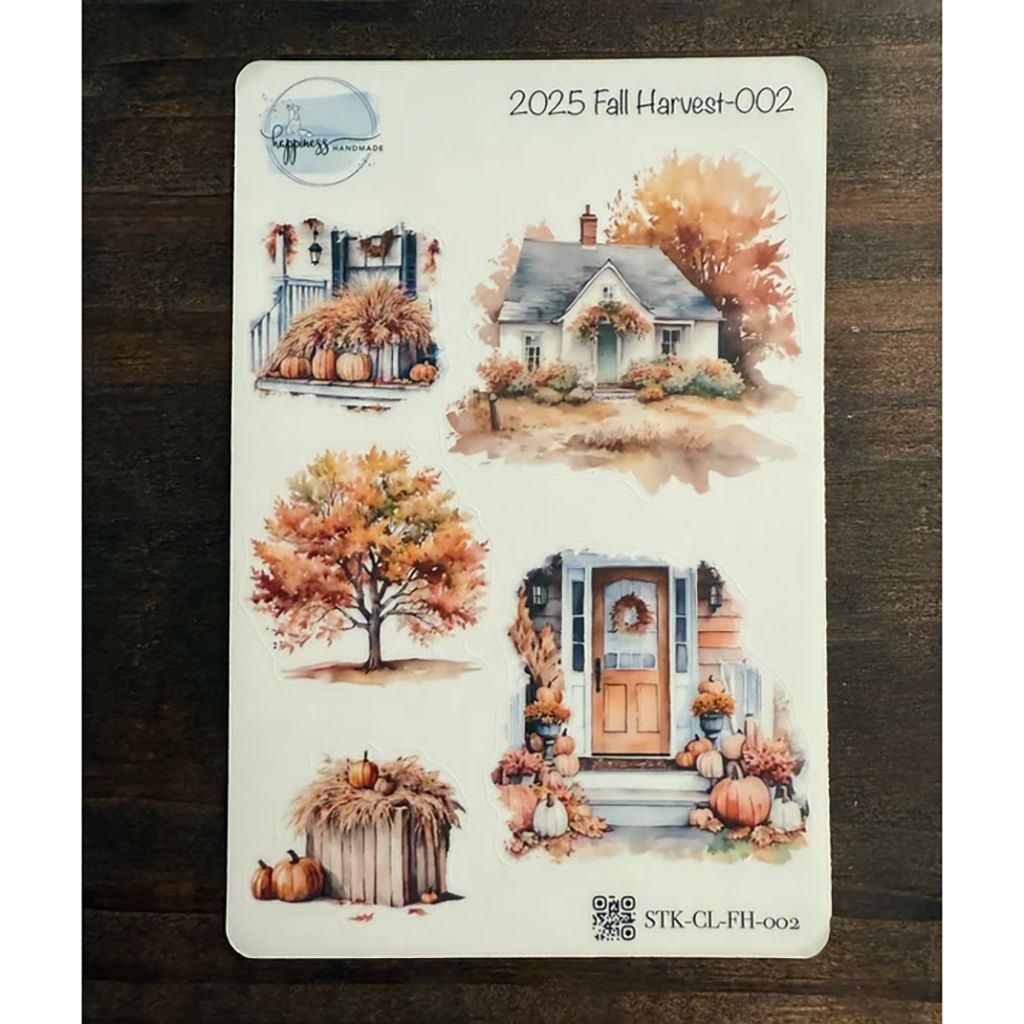 Sticker sheet with fall-themed designs on a wooden surface