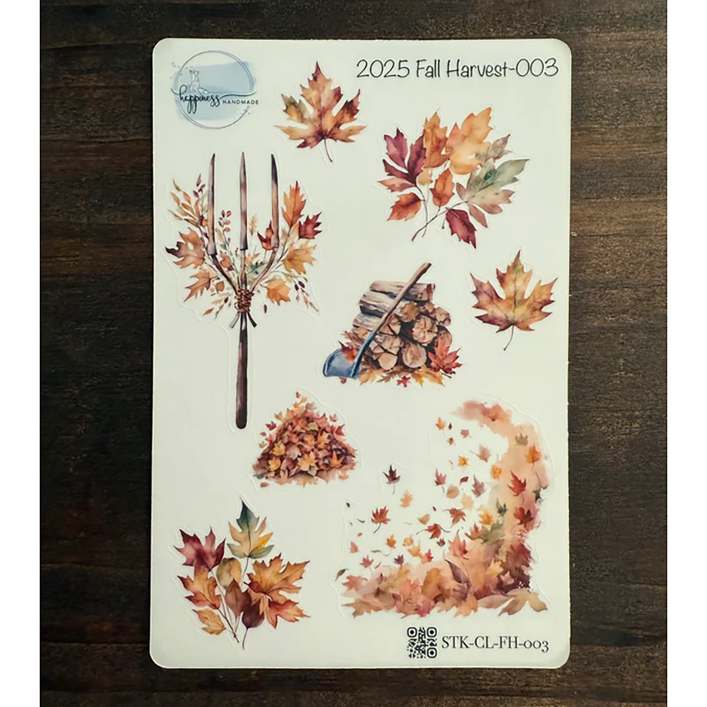 Sheet of autumn-themed temporary tattoos with leaves and harvest symbols on a wooden surface.