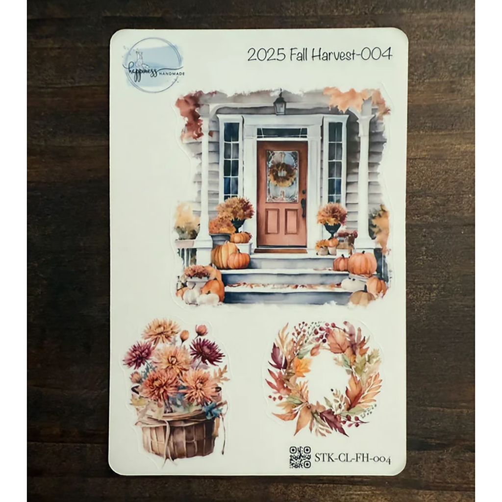 Sticker sheet with fall-themed design featuring pumpkins, flowers, and a wreath on a wooden surface.