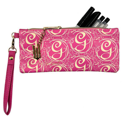 Pink and gold patterned pouch with a strap and pens on a white background