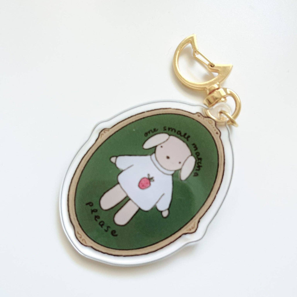 Kuboandlucy Keychain with cartoon character on a green background.  Available at Lighthouse Paper Co. in Melbourne, FL