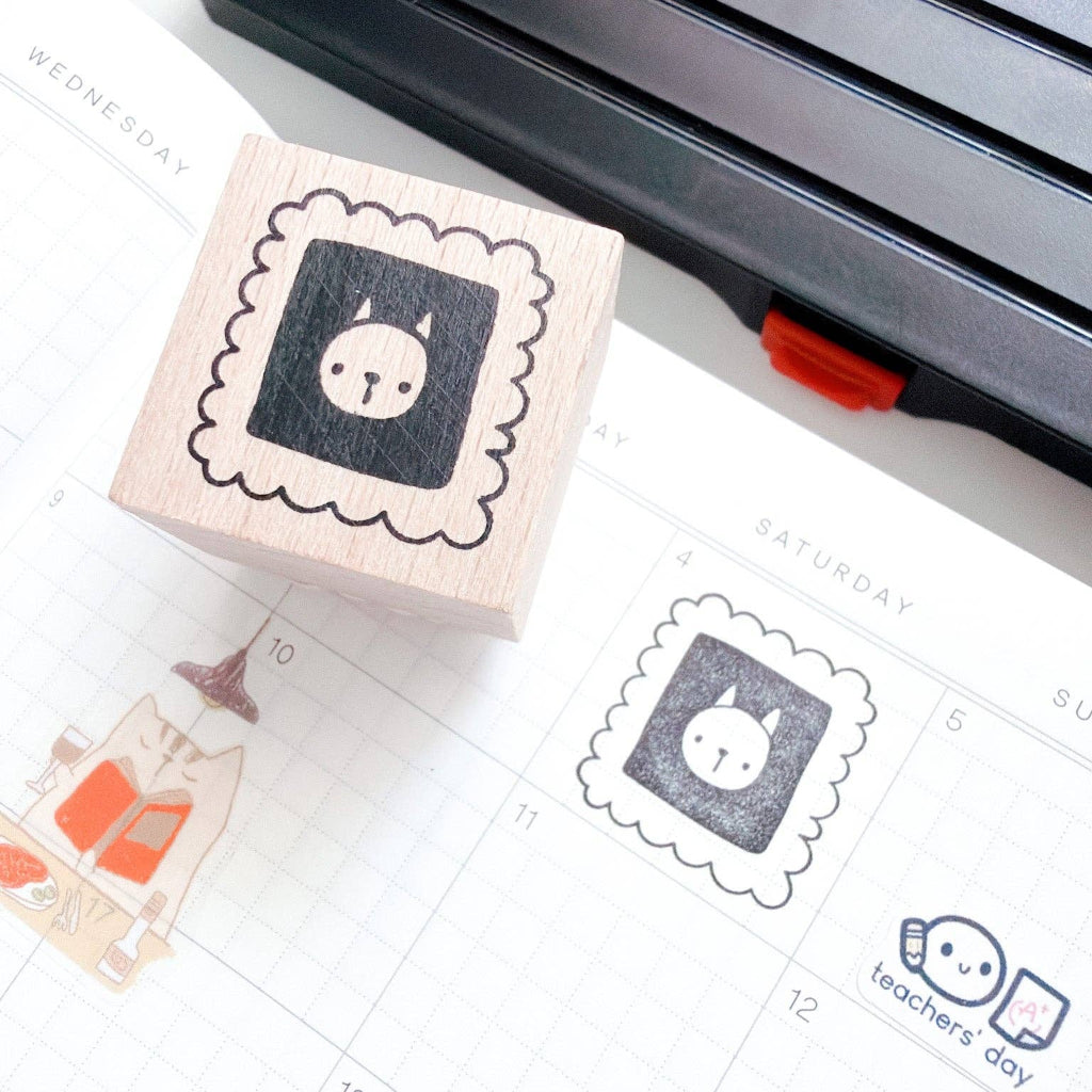 Rubber stamp with a cat design on a calendar