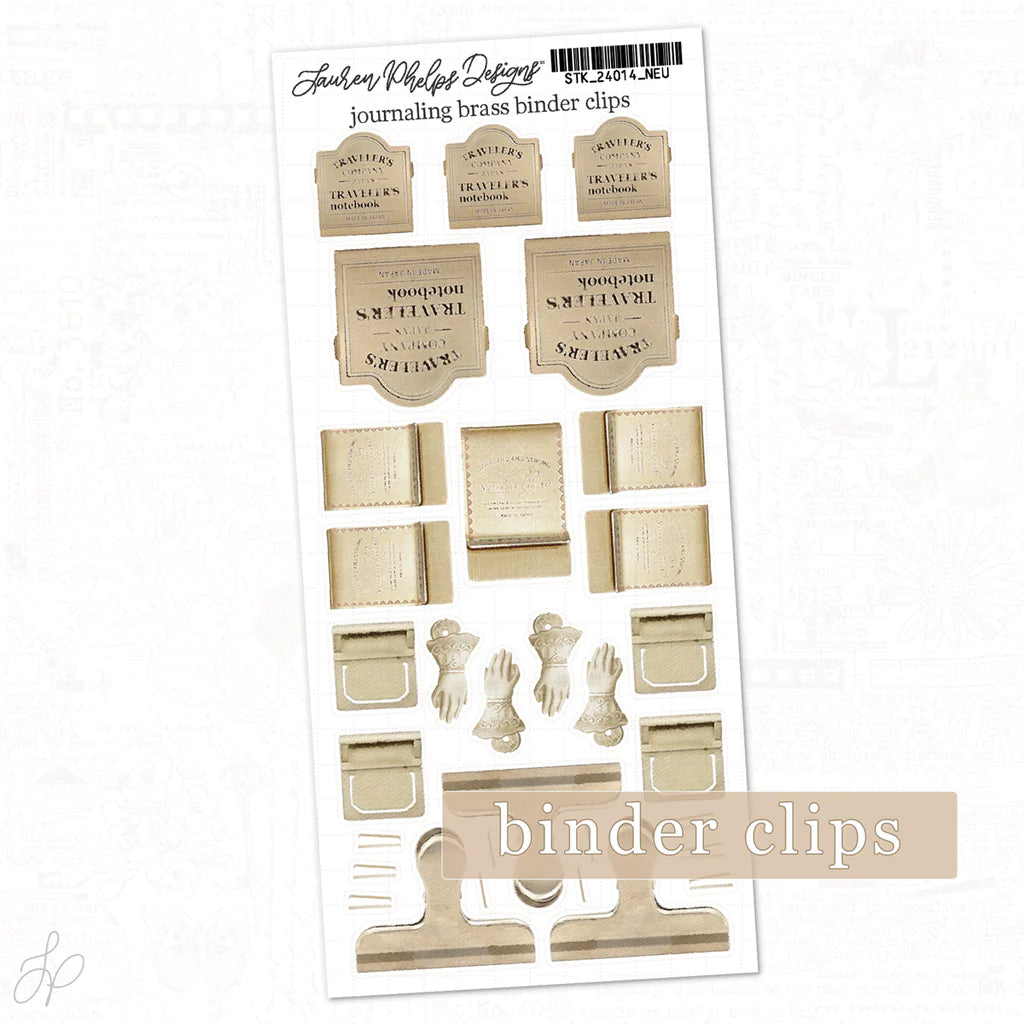 Sheet of journaling brass binder clips with a white background
