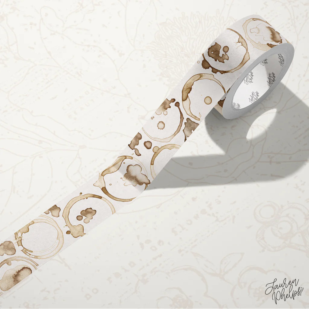 Roll of decorative tape with coffee cup design on a textured white background