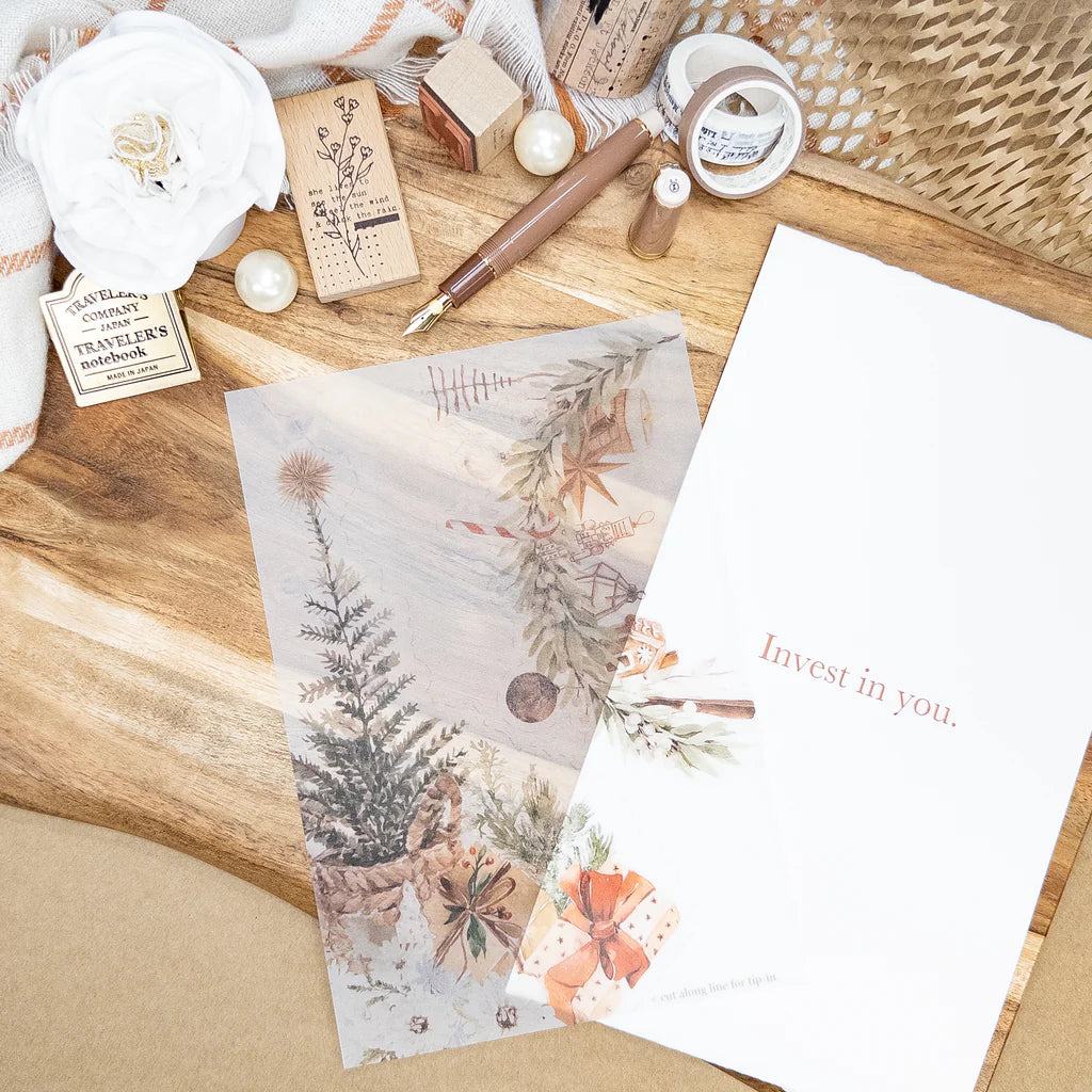 Stationery items including a pen, stamps, and printed paper on a wooden surface.