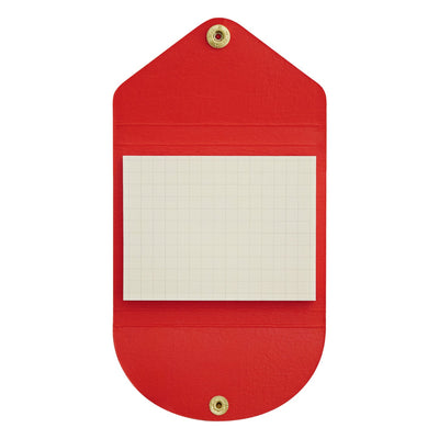 Red sticky note holder with a white notepad inside on a white background
