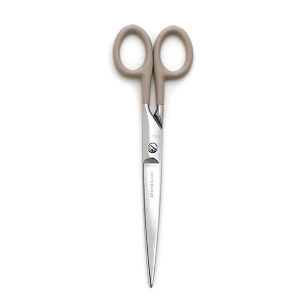 Pair of scissors with beige handles on a white background