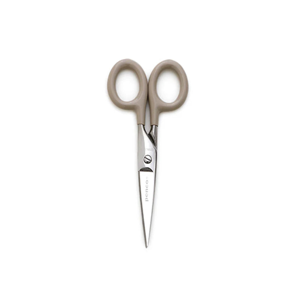 Pair of scissors with beige handles on a white background