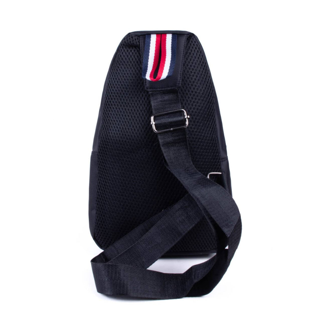 Black sling bag with a red, white, and blue strap on a white background