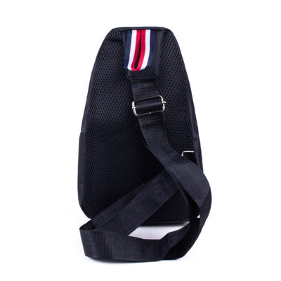 Black sling bag with a red, white, and blue strap on a white background