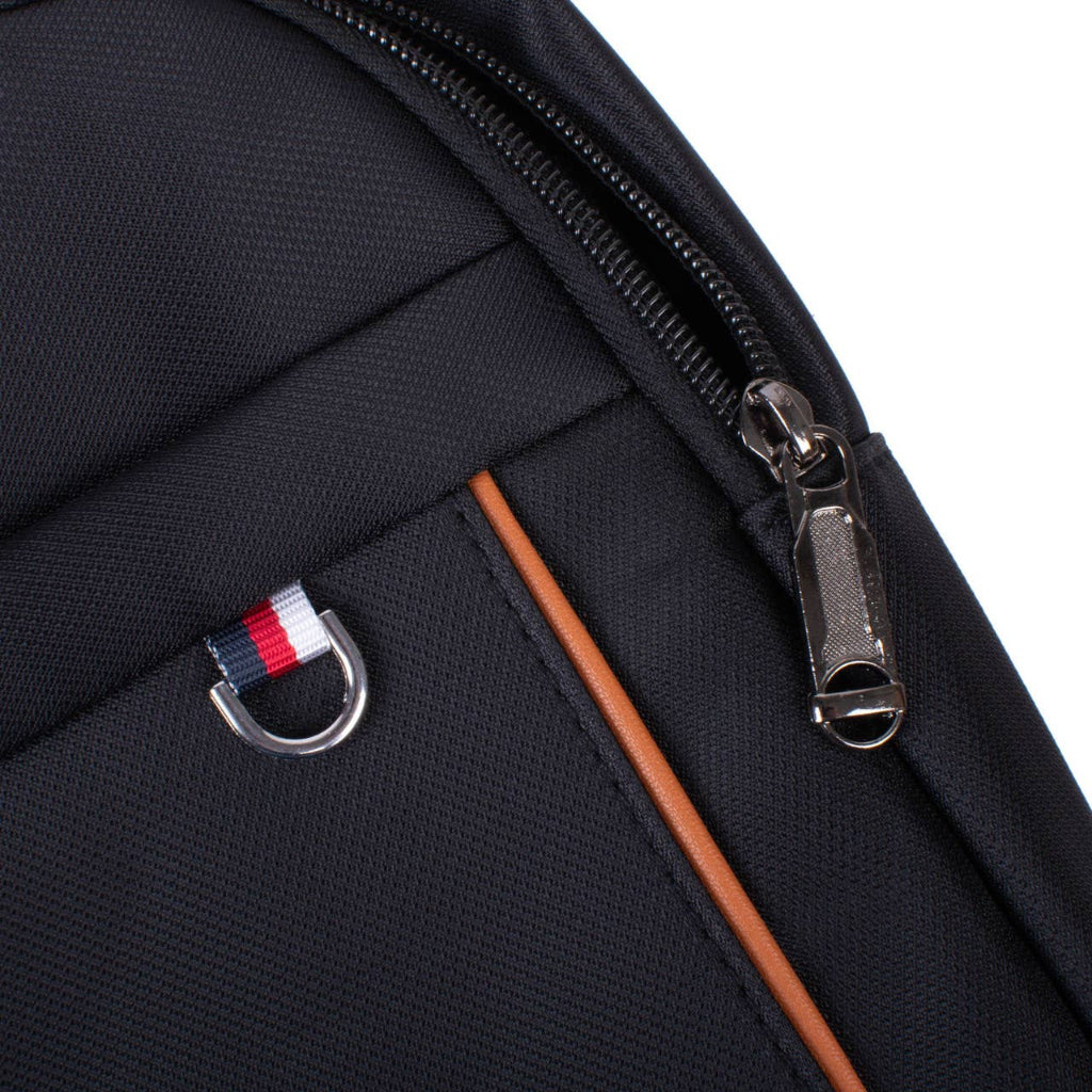 Close-up of a black bag with a zipper and a small flag emblem on a white background
