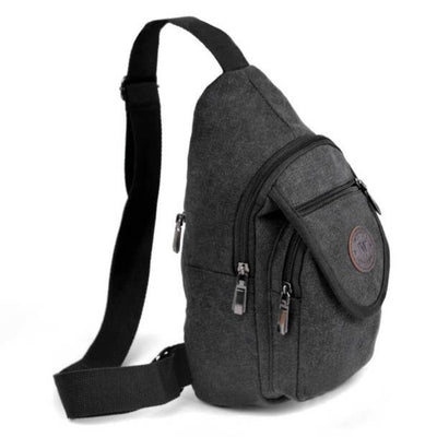 Gray sling bag with multiple zippers on a white background