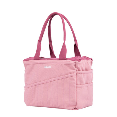 Pink tote bag with a visible brand logo on a white background
