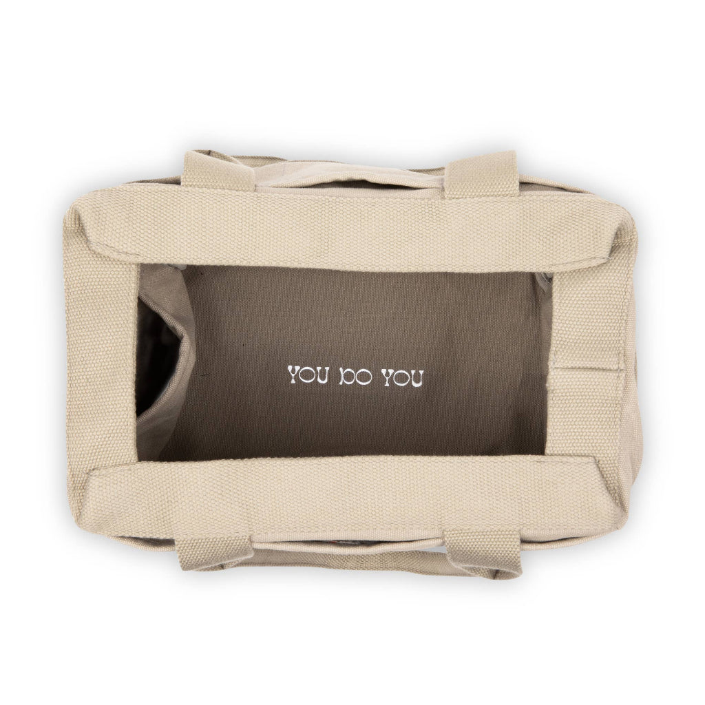 Beige bag with 'YOU DO YOU' text on a white background
