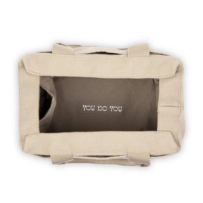 Beige bag with 'YOU DO YOU' text on a white background