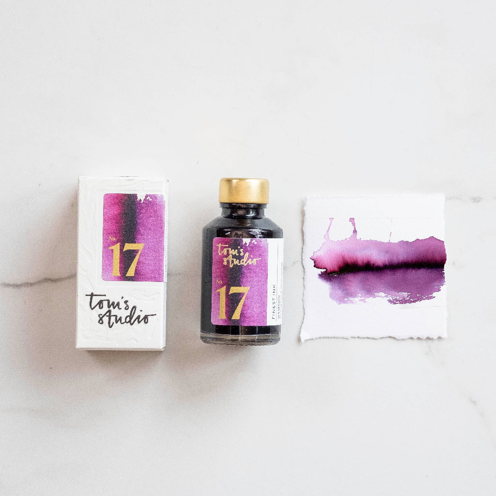 Tom's Studio Damson fountain pen ink bottle and packaging on a white background, available at Lighthouse Paper Co. in Melbourne, FL