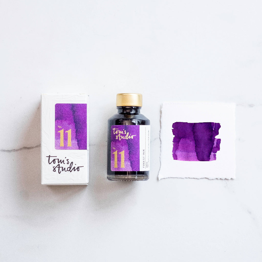 Tom's Studio Iris Ink bottle and packaging with 'Tom's Studio' branding on a white background, available at Lighthouse Paper Co. in Melbourne, FL