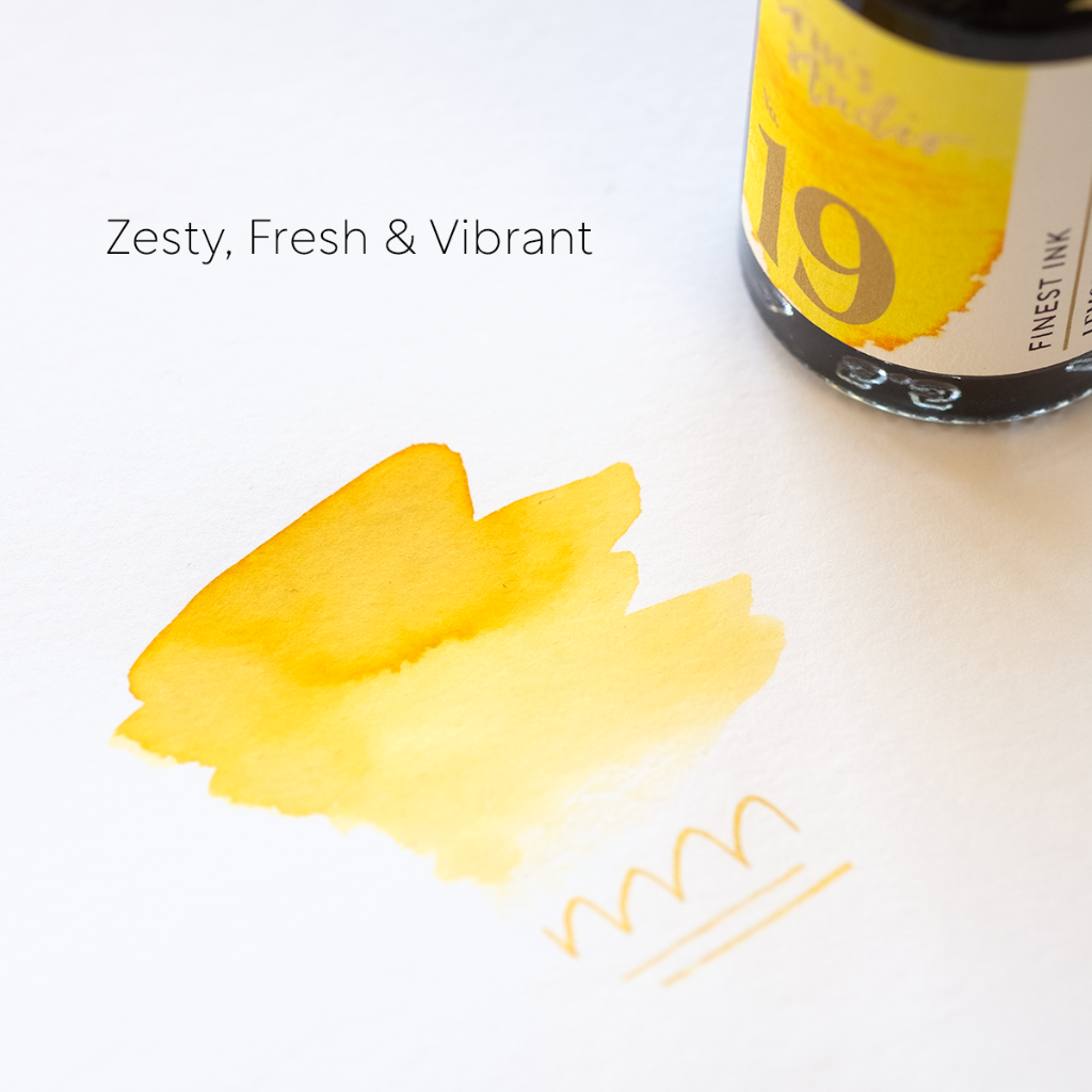 Bottle of 19th century ink with yellow ink swatch on a white background