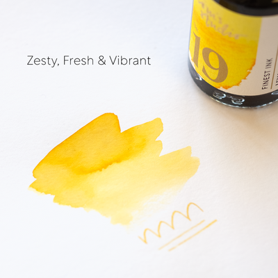 Bottle of 19th century ink with yellow ink swatch on a white background