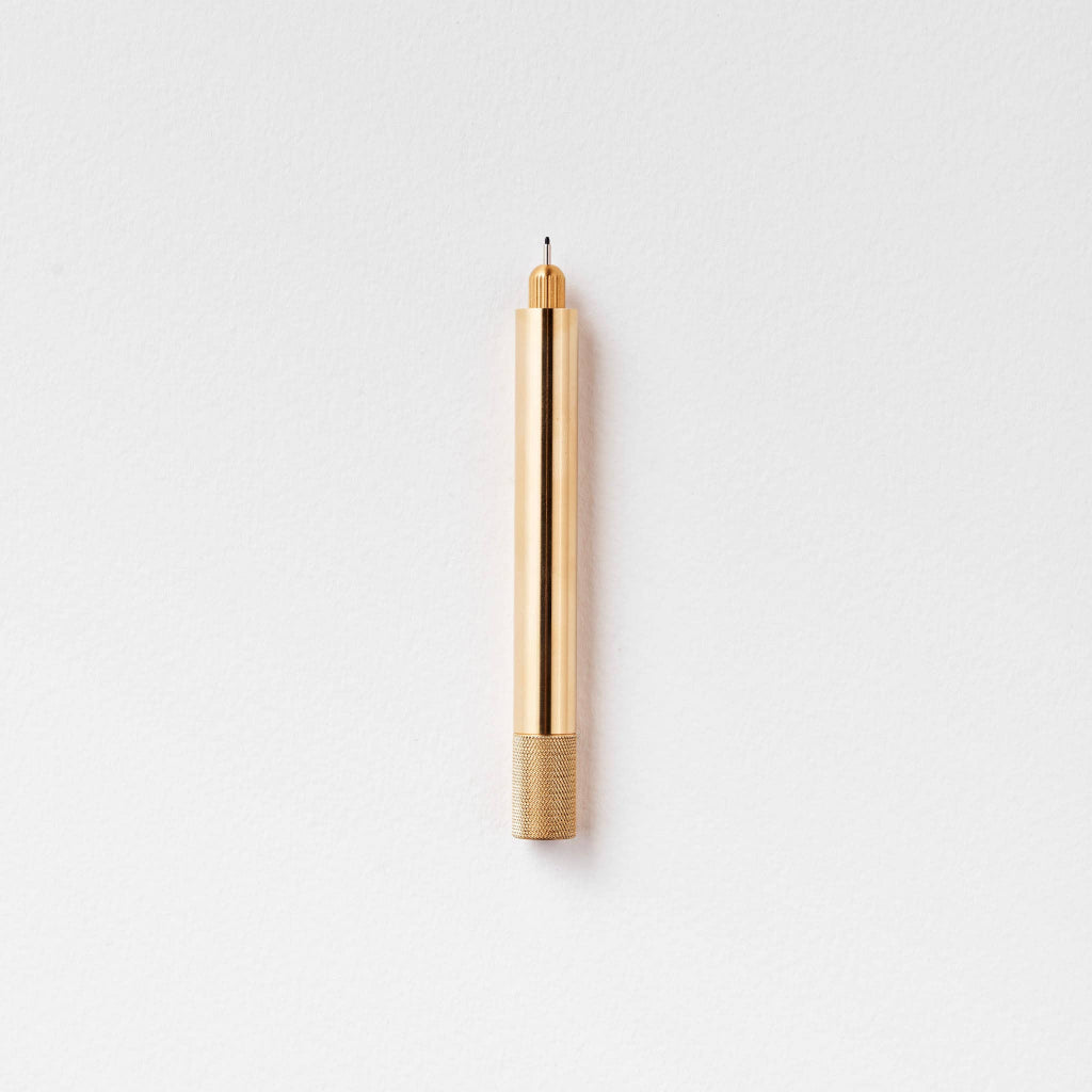 Tom's Studio Brass Lumos Pen on a light gray background, available at Lighthouse Paper Co. in Melbourne, FL