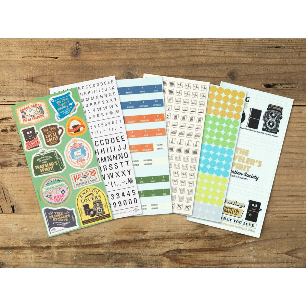 Collection of planner stickers on a wooden surface