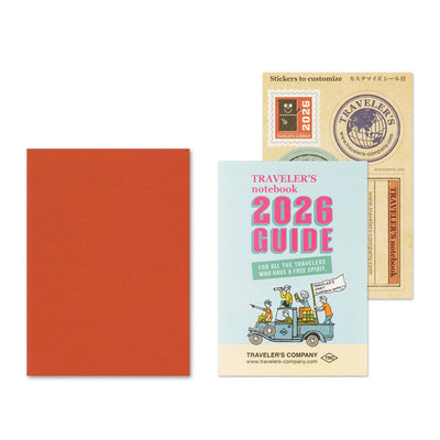 Traveler's notebook set with a red notebook, 2026 guidebook, and stickers on a white background.