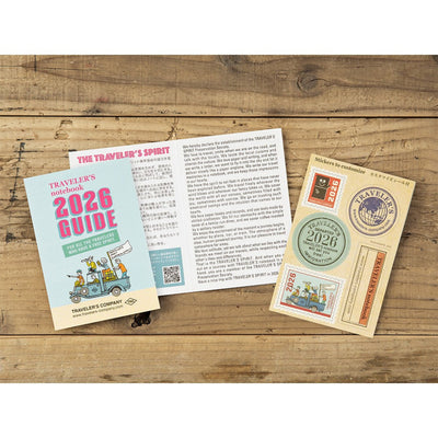 Traveler's Company 2026 Guidebook and stickers on a wooden surface