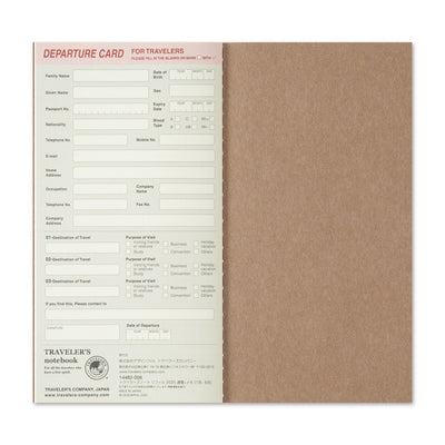 Traveler's notebook with departure card insert on a white background