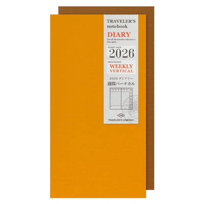 Orange notebook with brown cover and white label displaying 'Traveler's Company' and '2026 Weekly Vertical'.