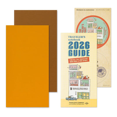 Traveler's notebook set with orange cover, brown back cover, and 2026 Guide book.