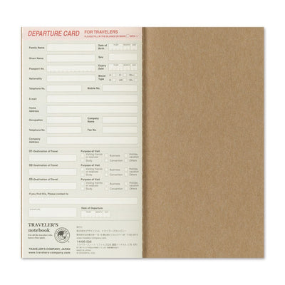 Traveler's notebook with departure card insert on a white background