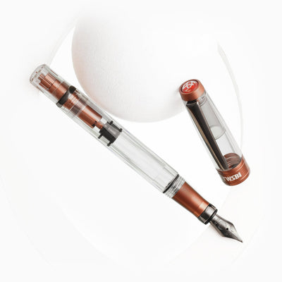 TWSBI Affogato with Onyx Fountain pen with transparent barrel and brown accents on a white background, available at Lighthouse Paper Co. in Melbourne, FL