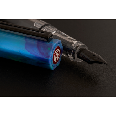 Fountain pen with blue barrel and visible brand logo on a dark background