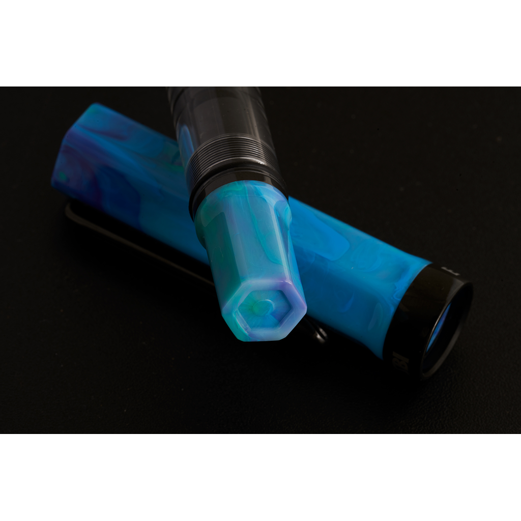 Blue and black fountain pen on a black background