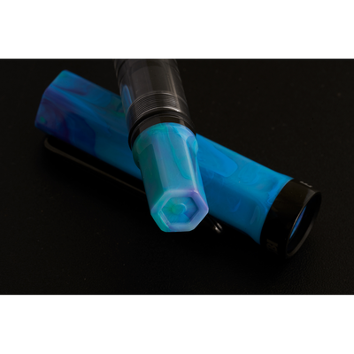 Blue and black fountain pen on a black background