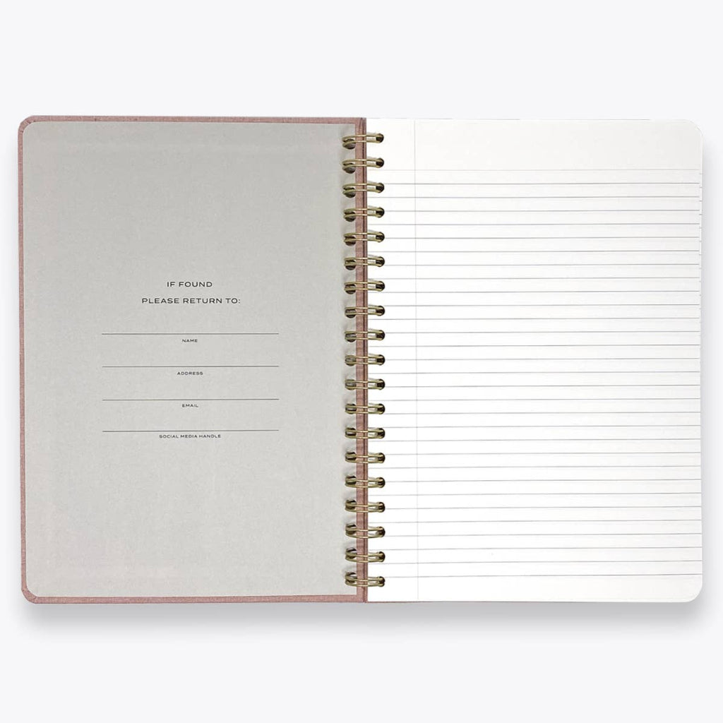Open spiral-bound notebook with lined pages on a white background